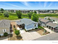 Charming single-Gathering home featuring a well-maintained yard and a mix of natural landscaping at 10573 Ashwood St # 334, Firestone, CO 80504