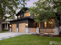 Stunning two-story home with a modern exterior, two-car garage, stone accents, and beautifully landscaped front yard at 1575 Kalmia Ave, Boulder, CO 80304