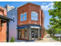 Charming brick building with large storefront windows and awnings, perfect for commercial use at 1941 Pearl St # 303, Boulder, CO 80302