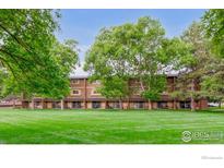 Well maintained building with mature trees and lush grass at 3161 Madison Ave # 313, Boulder, CO 80303