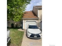 Inviting two-story townhouse with attached garage and well-maintained front lawn at 482 S Kalispell Way # E, Aurora, CO 80017