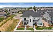 Inviting two-story home featuring modern farmhouse design with a manicured lawn and charming curb appeal at 760 Crossbill Dr, Berthoud, CO 80513
