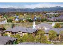 Stunning aerial view of condo building with mountain views in the background at 1122 Olympia Ave # 12H, Longmont, CO 80504