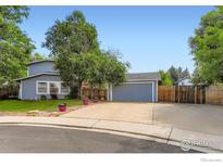 Charming home with a lovely front yard, mature trees, and a two-car garage at 1240 Snowbank Ct, Longmont, CO 80504