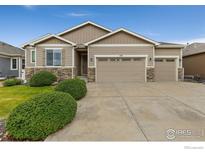 Charming single-story home features a three-car garage and well-maintained front yard with decorative stone accents at 1531 Alpine Ave, Berthoud, CO 80513