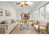 Bright living room featuring large windows, skylight, and modern furnishings, perfect for relaxing or entertaining at 2205 Keota Ln, Superior, CO 80027