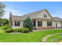 Charming home featuring manicured lawn and stone accents beneath the window at 2421 Santa Fe Dr # B, Longmont, CO 80504
