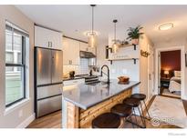 Bright kitchen featuring stainless steel appliances, pendant lighting, and breakfast bar with seating at 3025 Broadway St # 18, Boulder, CO 80304