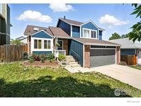 Charming two-story home with blue siding, brick accents, and a well-maintained front yard at 3593 S Gibralter Cir, Aurora, CO 80013