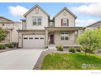 Charming home featuring a covered porch, a two-car garage, and a well-maintained front yard at 5226 Inland Ave, Firestone, CO 80504