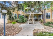 Inviting condominium with a charming exterior, landscaped entrance, and convenient access to upper-level units at 5918 Gunbarrel Ave # B, Boulder, CO 80301