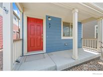 Inviting front porch with a vibrant red door and neutral trim accents at 67 Quail Rd, Longmont, CO 80501