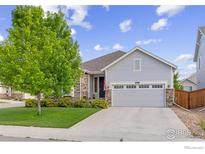 Charming single-Gathering home with a well-maintained lawn and a two-car garage on a sunny day at 688 Ten Gallon Dr, Berthoud, CO 80513