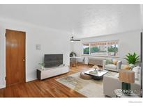 Bright living room featuring hardwood floors, large windows, and modern decor at 733 E 2Nd Ave # 307, Denver, CO 80203