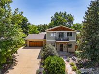 Charming two-story home featuring a balcony, lush landscaping, and a two-car garage at 1260 Claremont Dr, Boulder, CO 80305