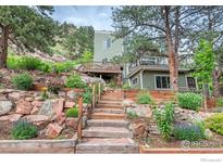 Beautiful two-story home with multiple wood decks, complemented by a professionally landscaped yard at 160 Valley Ln, Boulder, CO 80302