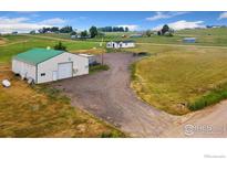 Spacious detached garage and workshop on a large grassy lot with mature trees and beautiful scenery at 18674 County Road 3, Berthoud, CO 80513
