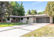 Charming ranch-style home featuring a spacious front yard, concrete driveway, and a two-car garage at 2025 Grape Ave, Boulder, CO 80304