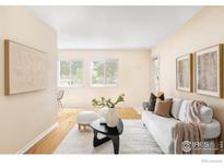 Bright living room with modern furnishings, art, hardwood floors, and a light-filled ambiance at 3393 Madison Ave # 128, Boulder, CO 80303