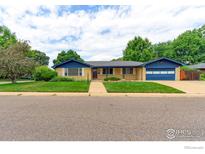 Charming home with a well-manicured lawn and blue trim accenting its architectural details under a beautiful sky at 353 S Niagara St, Denver, CO 80224