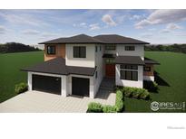 Contemporary two-story home featuring a three-car garage, stylish accents and well manicured landscaping at 848 Trail Ridge Dr, Louisville, CO 80027
