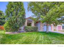 Charming single-Gathering home with stone accents, lush landscaping, and an inviting front yard at 10947 W 100Th Dr, Westminster, CO 80021