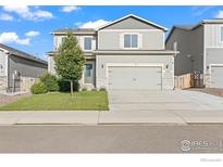 Charming two-story home with a manicured front yard, perfect for families or anyone seeking a cozy residence at 14827 Longhorn Dr, Mead, CO 80542