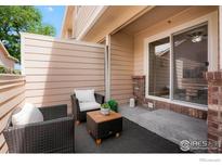 Inviting patio with seating and privacy fence, perfect for outdoor relaxation and entertaining guests at 1601 Great Western Dr # M2, Longmont, CO 80501