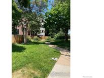 Lush green lawn and inviting pathway surrounded by mature trees and manicured landscaping at 2227 Canyon Blvd # 359B, Boulder, CO 80302
