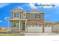 Charming two-story home featuring a two-car garage, covered porch, and stone accents, under construction at 226 Chardon Ave, Brighton, CO 80601