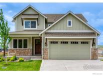Charming two-story home featuring a two-car garage, stone accents, and manicured lawn at 2397 Bristol St, Superior, CO 80027