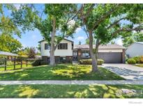 Charming two-story home with a well-manicured lawn and mature trees in a desirable neighborhood at 272 Lafayette St, Louisville, CO 80027
