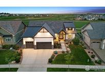 Beautifully landscaped home with a modern farmhouse design, three-car garage, and inviting curb appeal at 2932 Heron Lakes Pkwy, Berthoud, CO 80513