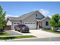 Charming home showcasing a well-manicured lawn and a spacious driveway leading to a two-car garage and inviting entrance at 2942 Merlin Dr, Brighton, CO 80601