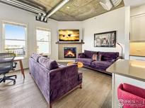 Inviting living room with modern design elements and a cozy fireplace at 3401 Arapahoe Ave # 402, Boulder, CO 80303
