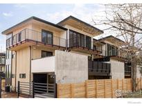 Modern townhome with wood and concrete accents, featuring private balconies and secure gated entry at 358 Arapahoe Ave # B, Boulder, CO 80302