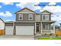 Two-story home featuring a three car garage, stone accents, neutral-toned siding and a covered porch at 4331 Gypsum Ave, Mead, CO 80504