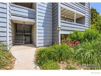 Inviting condo entrance with well-maintained landscaping, a welcoming staircase, and neutral-toned siding at 4670 White Rock Cir # 1, Boulder, CO 80301