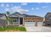 Charming single-story home featuring a stone facade and a three-car garage at 1144 Ridgefield Dr, Berthoud, CO 80513