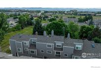 A neighborhood with tree-lined streets, sidewalks, and manicured lawns shows pride of ownership at 154 Blue Spruce Ct, Highlands Ranch, CO 80126