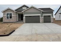 Beautifully designed single-Gathering home with a two-car garage and charming stone accents at 1713 Jennifer St, Brighton, CO 80601