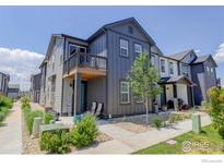 Charming townhome with vertical siding, balcony, and landscaped front yard at 173 Ambrose St, Erie, CO 80516