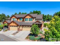 Charming home with lush landscaping, attached garage, and inviting curb appeal at 2005 Aster Ln, Lafayette, CO 80026