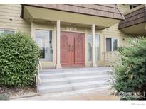 Inviting entrance with striking double doors, framed by glass panels and steps to the front at 3150 Iris Ave # 303, Boulder, CO 80301