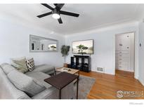 Inviting living room boasts hardwood floors, modern ceiling fan, and stylish decor at 3730 Lowell Blvd, Denver, CO 80211