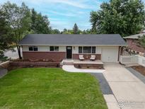 Charming single-story home with well-manicured lawn, brick accents, and inviting front porch at 1100 Berea Dr, Boulder, CO 80305