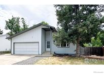 Charming single-Gathering home featuring an attached two-car garage, mature trees, and a welcoming front entrance at 11941 S Clayson St, Parker, CO 80138