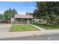 Charming two-story home with a well-maintained lawn and mature trees at 4655 Macky Way, Boulder, CO 80305