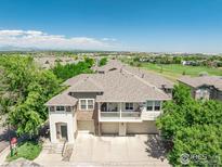 Charming townhome exterior showcasing a private balcony and attached garages in a well-maintained community at 12912 Grant E Cir # A, Thornton, CO 80241
