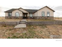 Attractive single Gathering home featuring a stone foundation and a welcoming front entrance at 16301 Hudson Rd, Hudson, CO 80642